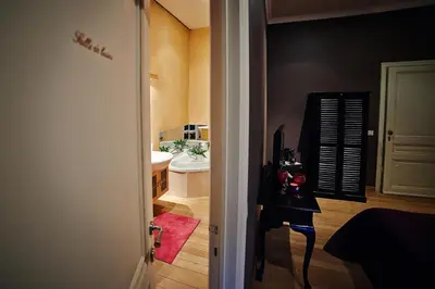 a hallway leading to a bathroom with a sink at B&B Au Clair Obscur in Verviers