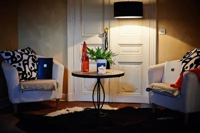 a room with two chairs and a table and a door at B&B Au Clair Obscur in Verviers