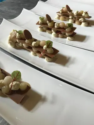 a row of white plates with food on them at B&B Au Clair Obscur in Verviers