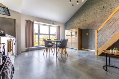 a dining room with a table and chairs at De Hoog Velden 13 in Pelt