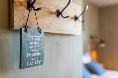 a sign hanging on a wall in a bedroom at guesthouse Kamiele bij Lavendine Pure in Genk