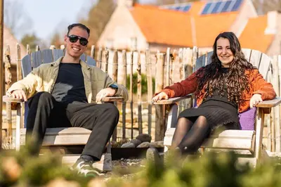 a man and a woman sitting in lawn chairs at guesthouse Kamiele bij Lavendine Pure in Genk