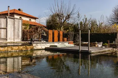 a house sitting on top of a body of water at guesthouse Kamiele bij Lavendine Pure in Genk