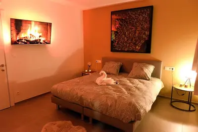 a bedroom with a bed with a stuffed animal on it at SuiteDreams - Sky Suite - Liège in Liège