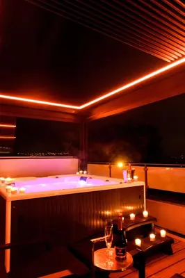 a jacuzzi tub in a room with lights at SuiteDreams - Sky Suite - Liège in Liège