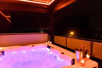 a bath tub on a balcony with a view at SuiteDreams - Sky Suite - Liège in Liège