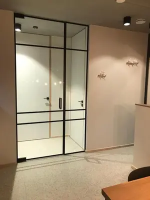 a large glass door in a room at Shelter in Zutendaal