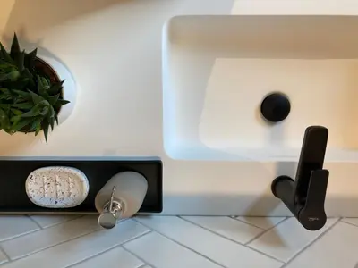 a bathroom with a sink and a potted plant at Shelter in Zutendaal