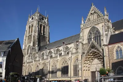 a large cathedral with a tower and a clock at Holiday Home 't Regulierenhuisje in Tongeren