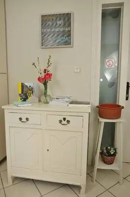 a white dresser with a vase of flowers on it at Holiday Home 't Regulierenhuisje in Tongeren