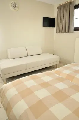 a living room with a couch and a table at Holiday Home 't Regulierenhuisje in Tongeren