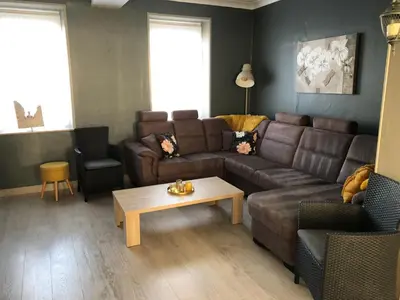 a living room with a couch and a coffee table at Hoeve Terwinghe in Gingelom