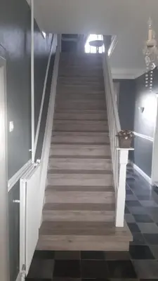 a staircase in a room with a stair case at Hoeve Terwinghe in Gingelom