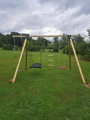 a swing set in a grassy field at Hoeve Terwinghe in Gingelom