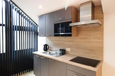 a kitchen with a sink and a counter at Recreatiedomein Warredal - The Lodge in Neeroeteren
