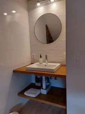 a bathroom with a sink and a mirror at Entre Deux Eaux in Lanaken