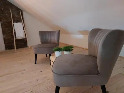 two chairs sitting next to each other in a room at Entre Deux Eaux in Lanaken
