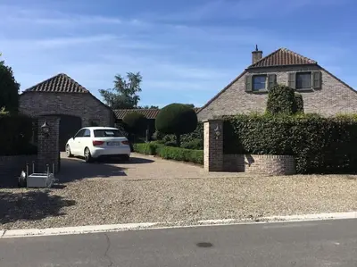 a white car parked in front of a house at Vakantiehuis de wereldburger Worldcitizen in Oudsbergen