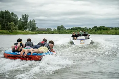 a group of people riding on a raft on the water at Camping de Boomgaard in Maaseik