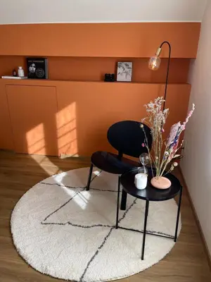 a living room with a chair and a table at Vakantieappartement Logies Terhagen in Zoutleeuw