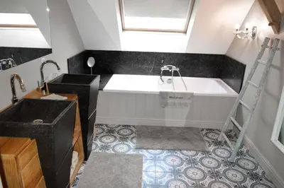 a bathroom with a large tub and a sink at Hoeve Lavigne in Wellen