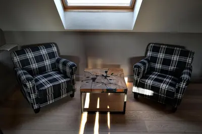 two chairs and a coffee table in a living room at Hoeve Lavigne in Wellen