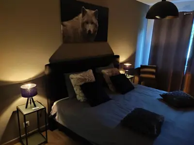 a bedroom with a bed with a picture of a wolf at Gîte La Renéade in Foyr