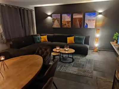 a living room with a couch and a table at Gîte La Renéade in Foyr