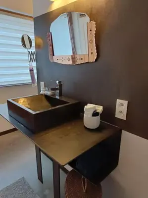 a bathroom with a black sink and a mirror at Loft, parking privé, terrasse, entrée indépendante in Liège