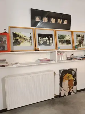 a white counter with pictures on top of it at Loft, parking privé, terrasse, entrée indépendante in Liège
