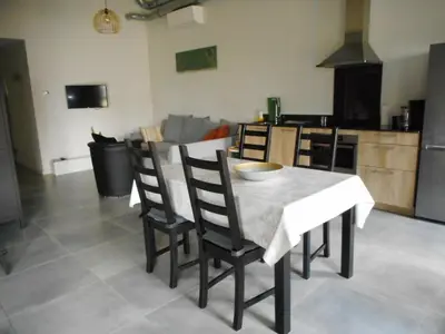 a kitchen and dining room with a table and chairs at De Hoog Velden 14 in Pelt