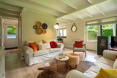 a living room with a couch and a table at Boshuisje Rekem - Rivus in Lanaken