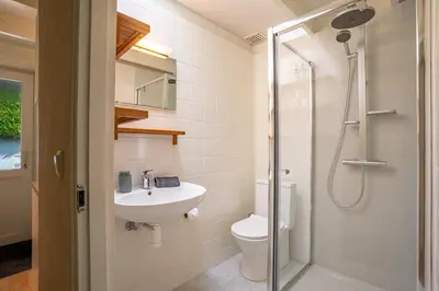 a bathroom with a toilet and a sink and a shower at Boshuisje Rekem - Rivus in Lanaken