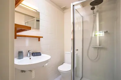 a bathroom with a toilet sink and a shower at Boshuisje Rekem - Rivus in Lanaken