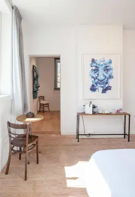 a room with a bed and a chair and a table at Le Charbonnage in Genk