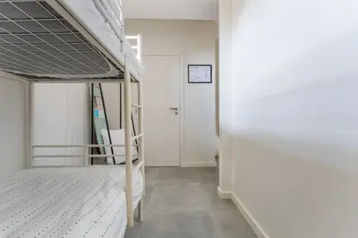 a bedroom with a bunk bed and a hallway at De Hoog Velden 12 in Pelt