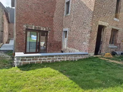 a brick building with a window on the side of it at Gîte Eschen in Plombières