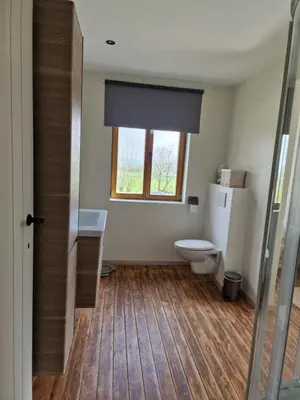 a bathroom with a toilet and a window at Gîte Eschen in Plombières