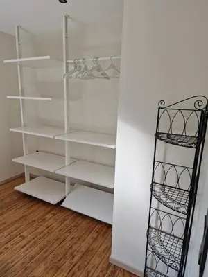 a walk in closet with white shelves at Gîte Eschen in Plombières