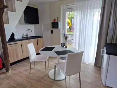 a kitchen and dining room with a table and chairs at Gîte Eschen in Plombières