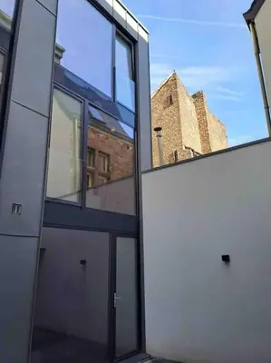 anexternal view of a building with glass windows at Triplex d'architecte en hypercentre in Liège