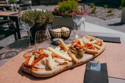 a plate of food on a table with wine glasses at Domaine des Thermes in Awans