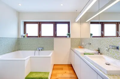 a bathroom with two sinks and a tub at Penthouse Hors-Château in Liège