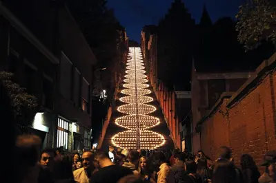 a crowd of people walking down a street at night at Penthouse Hors-Château in Liège
