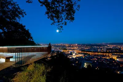 a bench on a hill with a view of a city at Penthouse Hors-Château in Liège