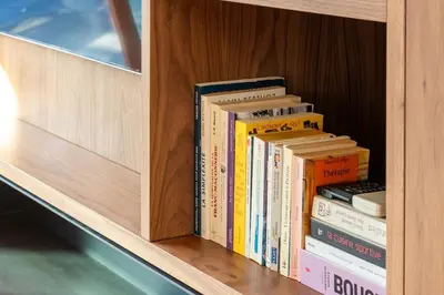 a stack of books sitting on a shelf at Penthouse Hors-Château in Liège