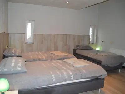 a room with three beds and two windows at Verviers Villa with Sauna in Verviers