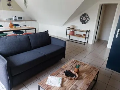 a living room with a couch and a coffee table at Ô Baguenaudes in Jalhay