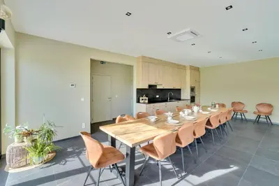 a large dining room with a long table and chairs at Franciscushof in Pelt