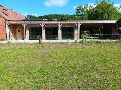 a brick building with a yard in front of it at Franciscushof in Pelt